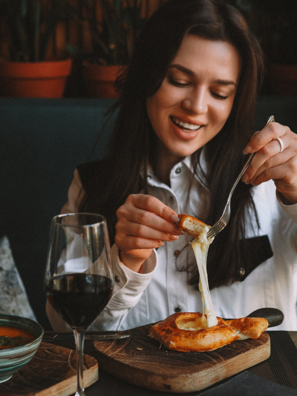 Guest enjoying appetizers and wine at The Buzz